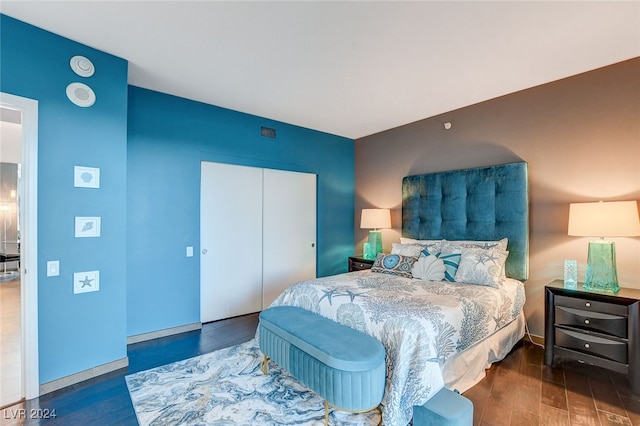 bedroom with a closet and dark wood-type flooring