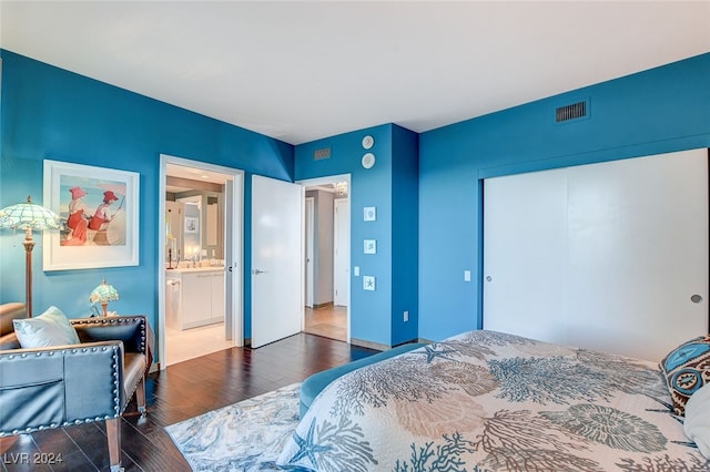 bedroom featuring connected bathroom and dark hardwood / wood-style floors