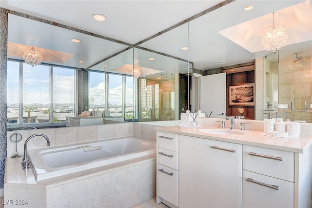 bathroom with vanity, plus walk in shower, and a notable chandelier