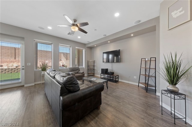 living room with wood-type flooring and ceiling fan