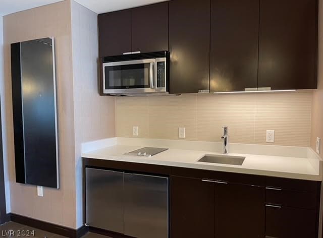 kitchen with dark brown cabinets and sink