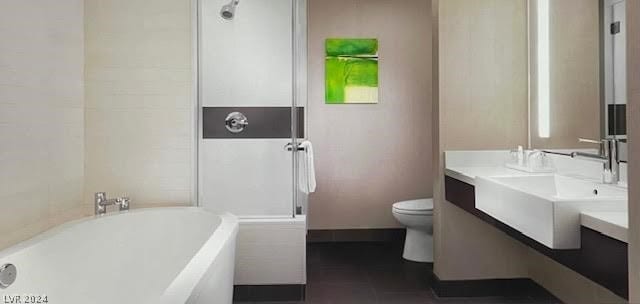 bathroom featuring a bath, tile flooring, toilet, and vanity