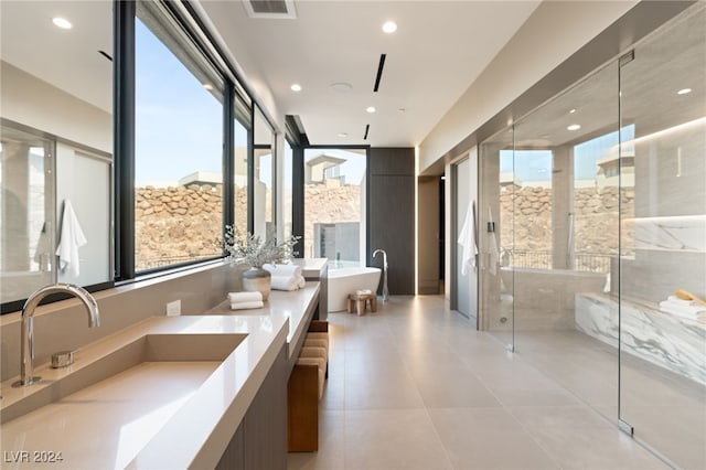 bathroom featuring tile patterned floors, vanity, and separate shower and tub