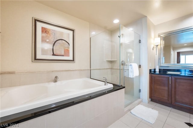 bathroom with plus walk in shower, tile patterned flooring, and vanity