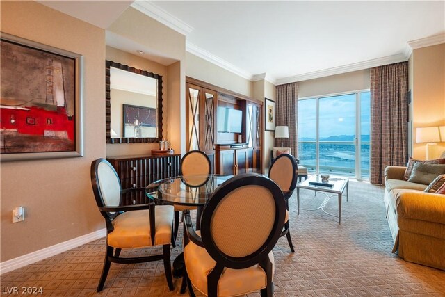 dining room with carpet and crown molding