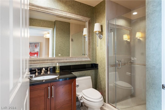 bathroom with vanity, an enclosed shower, and toilet