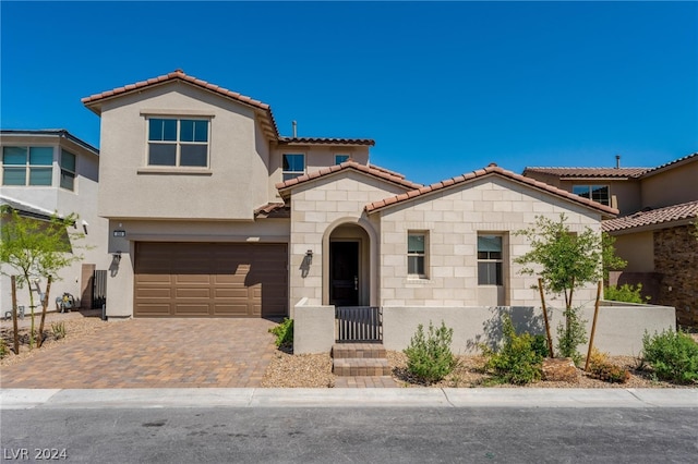 mediterranean / spanish-style home featuring a garage