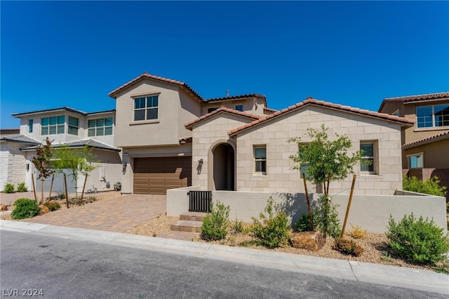 mediterranean / spanish-style home featuring a garage