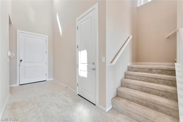 entryway featuring light carpet