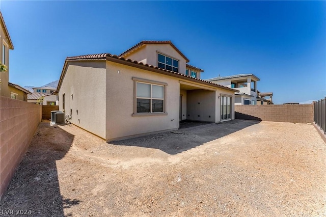 rear view of property with central AC unit