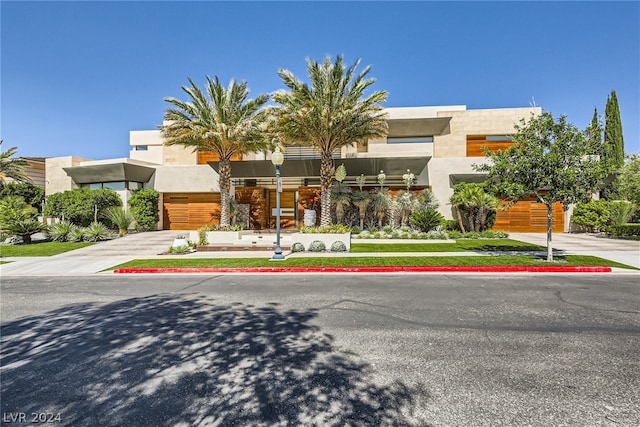 view of front of house with concrete driveway and stucco siding