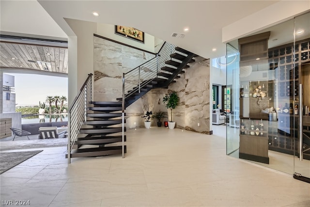 interior space featuring recessed lighting, visible vents, and a high ceiling