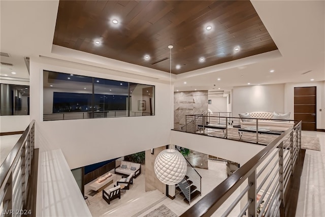 interior space featuring wood ceiling, a raised ceiling, and recessed lighting