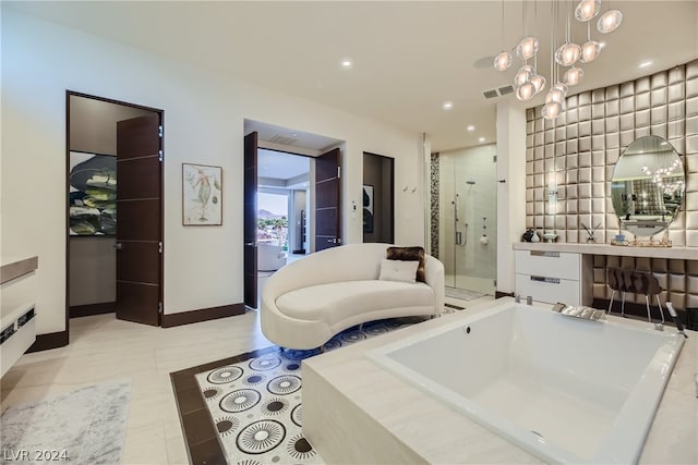 bathroom with tile flooring, an inviting chandelier, vanity, and plus walk in shower