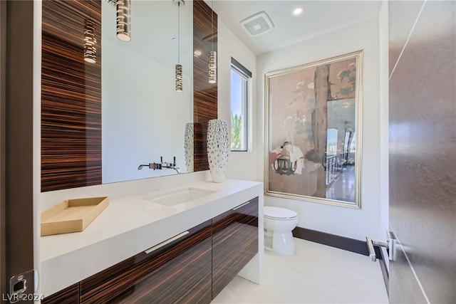 bathroom featuring baseboards, toilet, tile patterned flooring, vanity, and recessed lighting