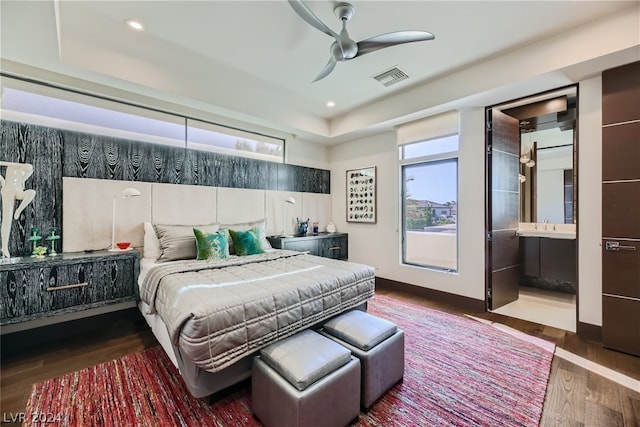 bedroom with sink, connected bathroom, wood-type flooring, and ceiling fan