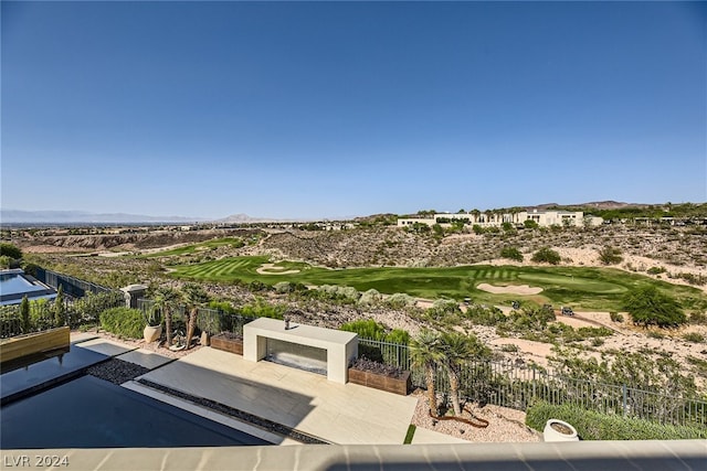 surrounding community with a patio area, fence, golf course view, and a mountain view