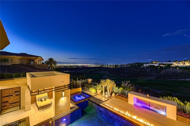 view of swimming pool featuring a patio, an outdoor kitchen, fence, and a pool with connected hot tub