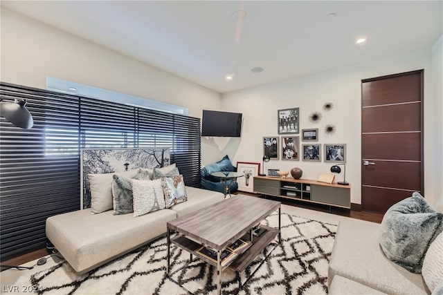 living area featuring wood finished floors and recessed lighting