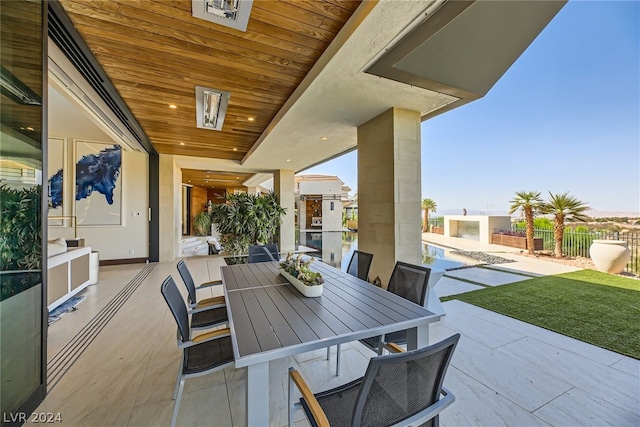 view of patio featuring outdoor dining space and fence