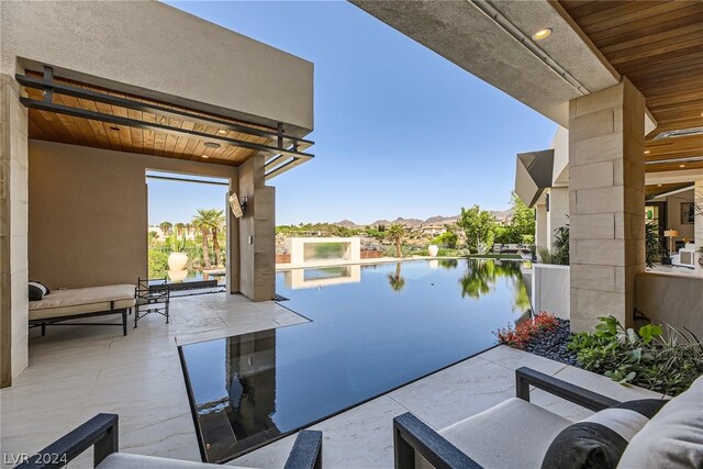 view of patio / terrace featuring outdoor lounge area and a water view