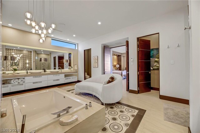 bathroom featuring a bath to relax in, dual bowl vanity, tile flooring, and a chandelier