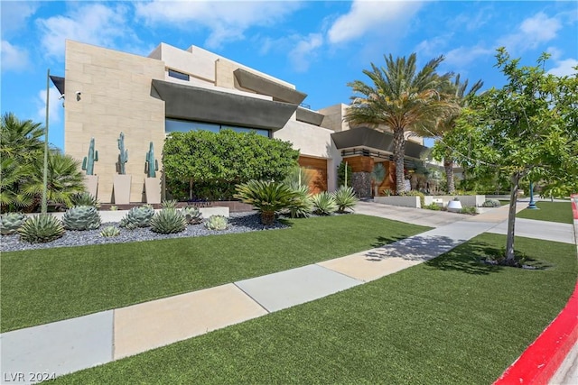 view of front of property with stucco siding and a front yard