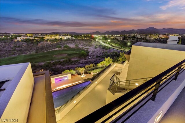 view of pool at dusk