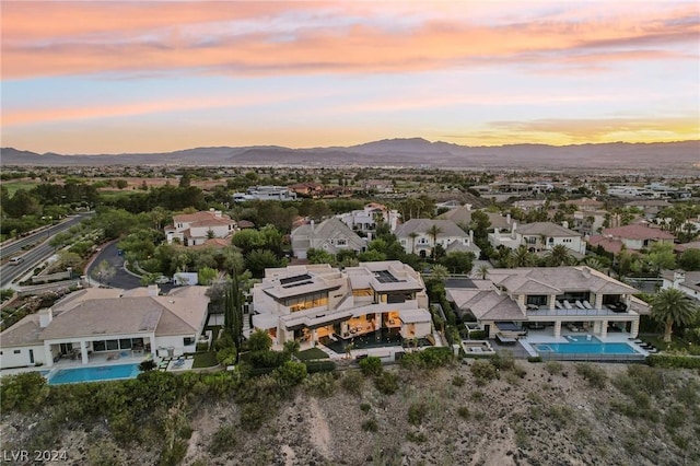 aerial view at dusk with a residential view and a mountain view