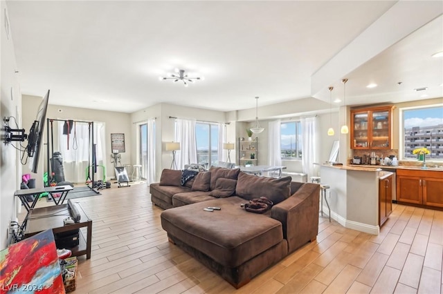 living room with sink and light hardwood / wood-style flooring