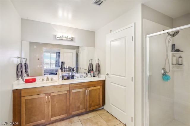 bathroom featuring tile patterned flooring, vanity, and an enclosed shower