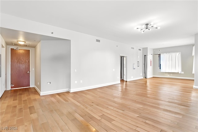 unfurnished room with light wood-type flooring