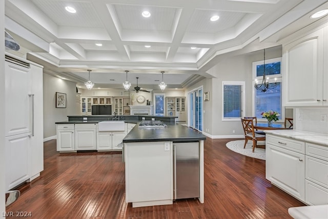 kitchen with white cabinetry, a kitchen island, dark hardwood / wood-style flooring, pendant lighting, and coffered ceiling