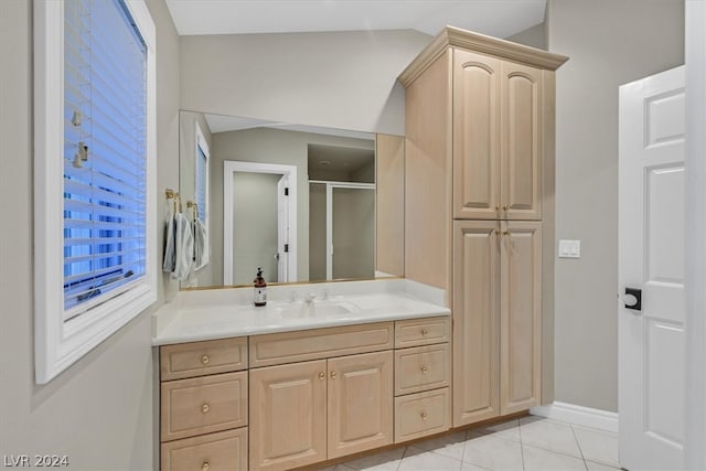 bathroom with tile floors, lofted ceiling, and vanity