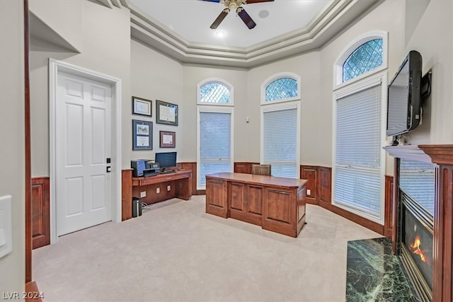 office area with ornamental molding, a tray ceiling, a towering ceiling, carpet flooring, and ceiling fan