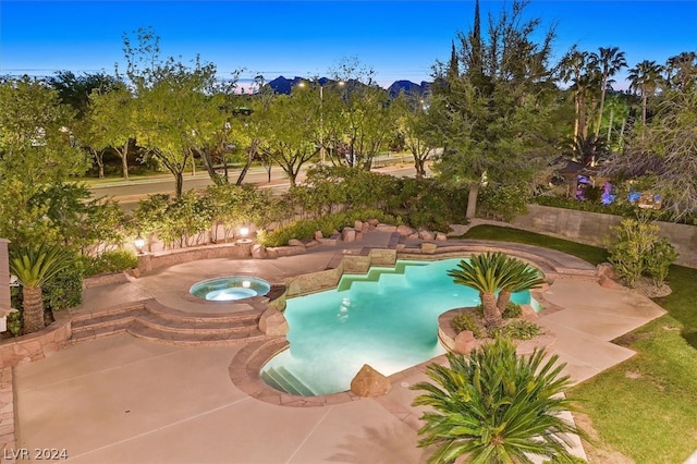 view of swimming pool with a patio and an in ground hot tub