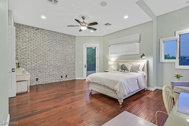 bedroom with brick wall, hardwood / wood-style flooring, ceiling fan, and access to outside