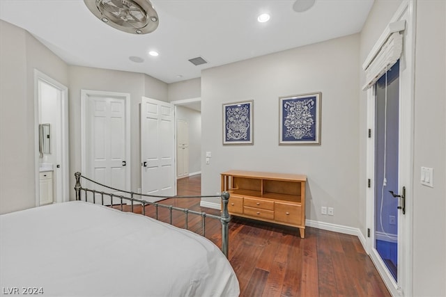 bedroom featuring dark wood-type flooring and connected bathroom