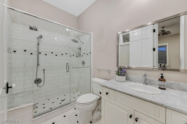 bathroom featuring tile floors, an enclosed shower, large vanity, and toilet