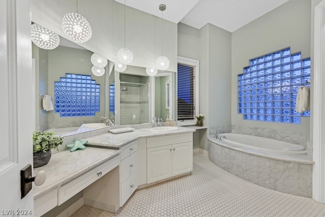 bathroom featuring a notable chandelier, tiled bath, vanity, and tile floors