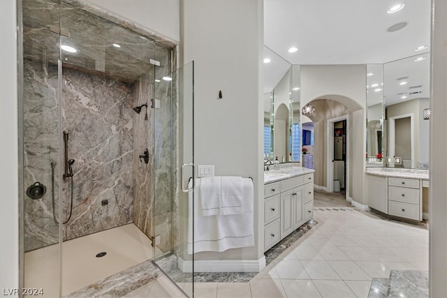 bathroom featuring walk in shower, tile flooring, and vanity