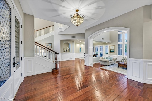 foyer featuring wood-type flooring and an inviting chandelier