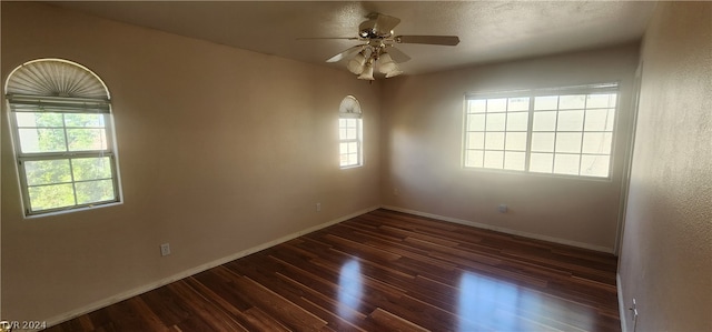 unfurnished room featuring ceiling fan and dark hardwood / wood-style flooring