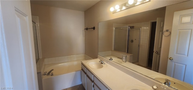 bathroom with shower with separate bathtub and double vanity