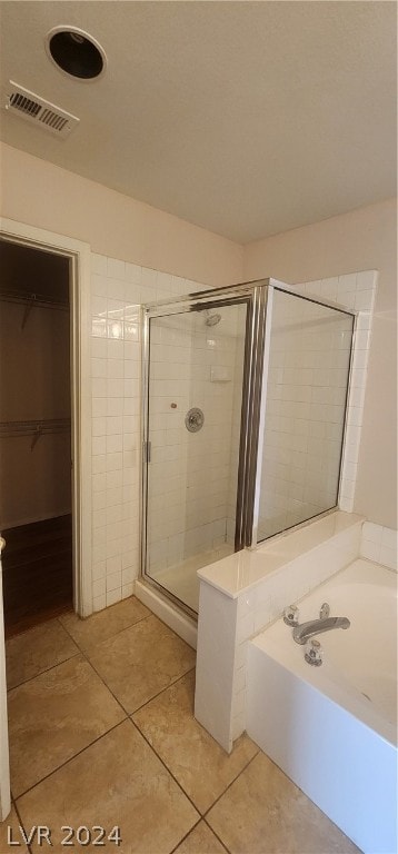 bathroom with tile floors and plus walk in shower