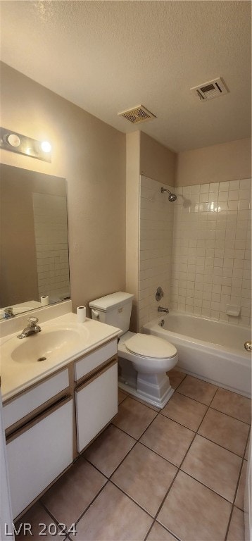 full bathroom with tiled shower / bath, vanity, toilet, and tile flooring