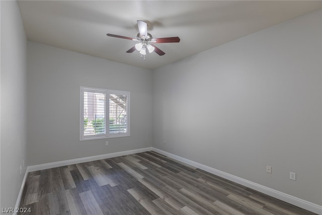 empty room featuring dark wood-type flooring and ceiling fan