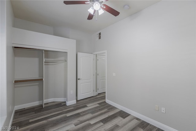 unfurnished bedroom featuring a closet, wood-type flooring, and ceiling fan