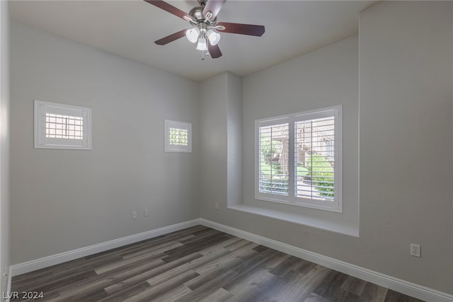 empty room with ceiling fan and dark wood-type flooring