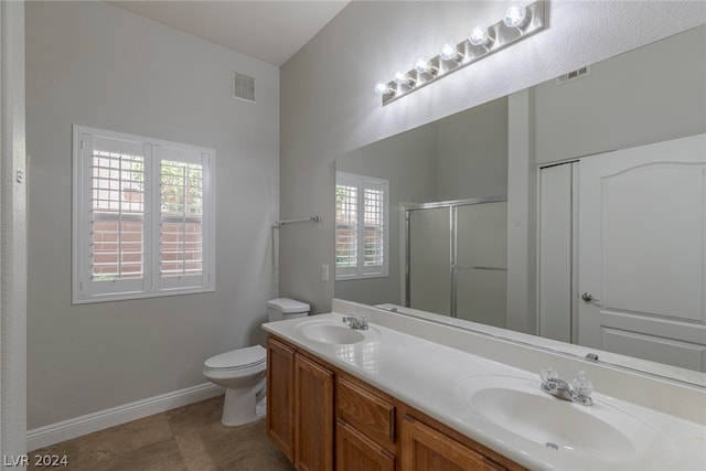 bathroom featuring vanity with extensive cabinet space, double sink, toilet, and tile floors